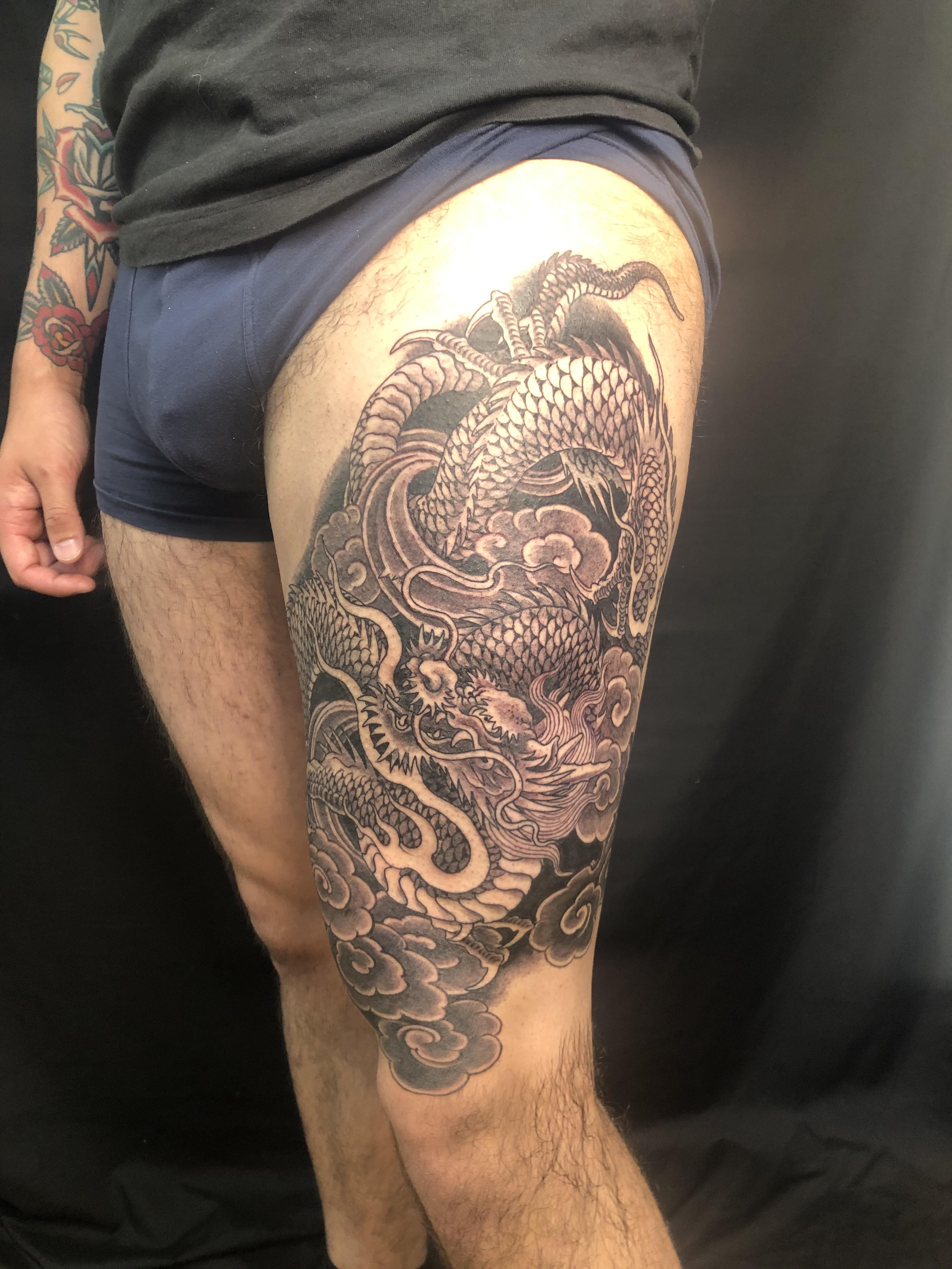 bold dragon leg tattoos for men