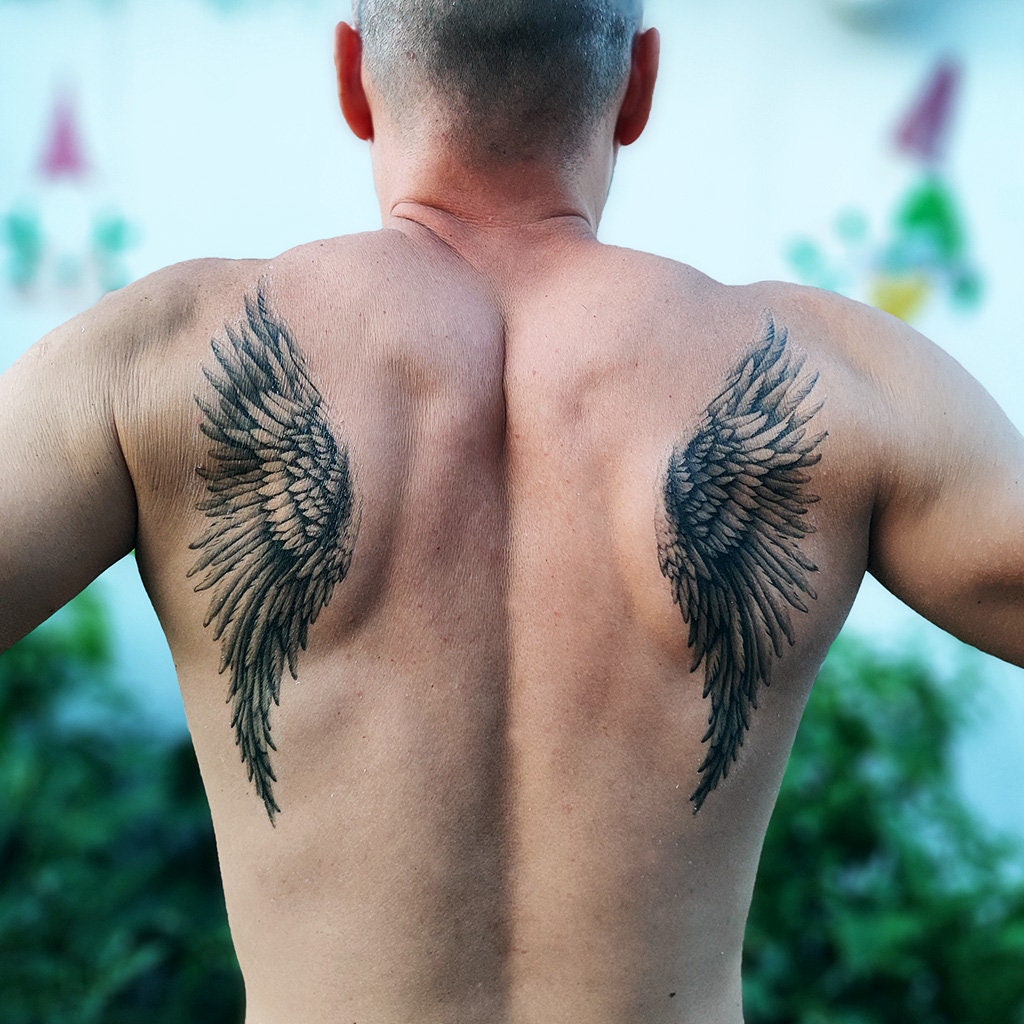 bold mens wing tattoo for the back options.