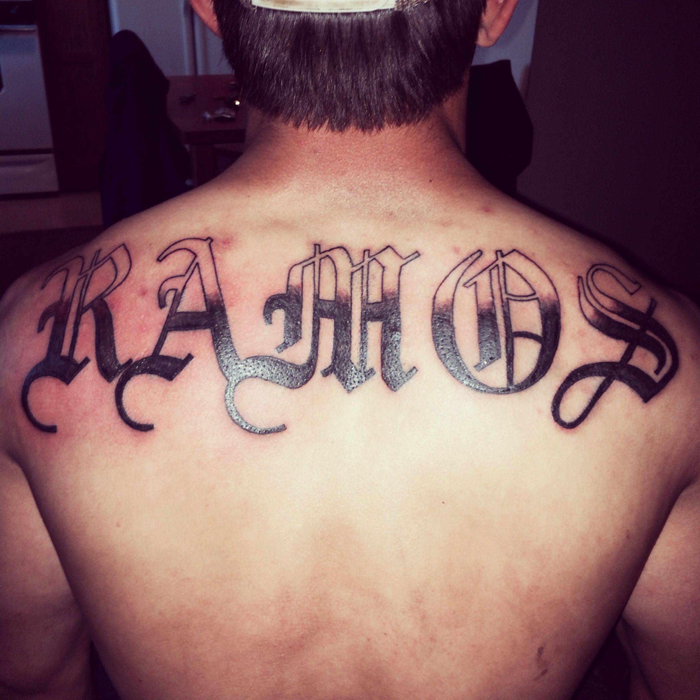 creative last name back tattoos for men