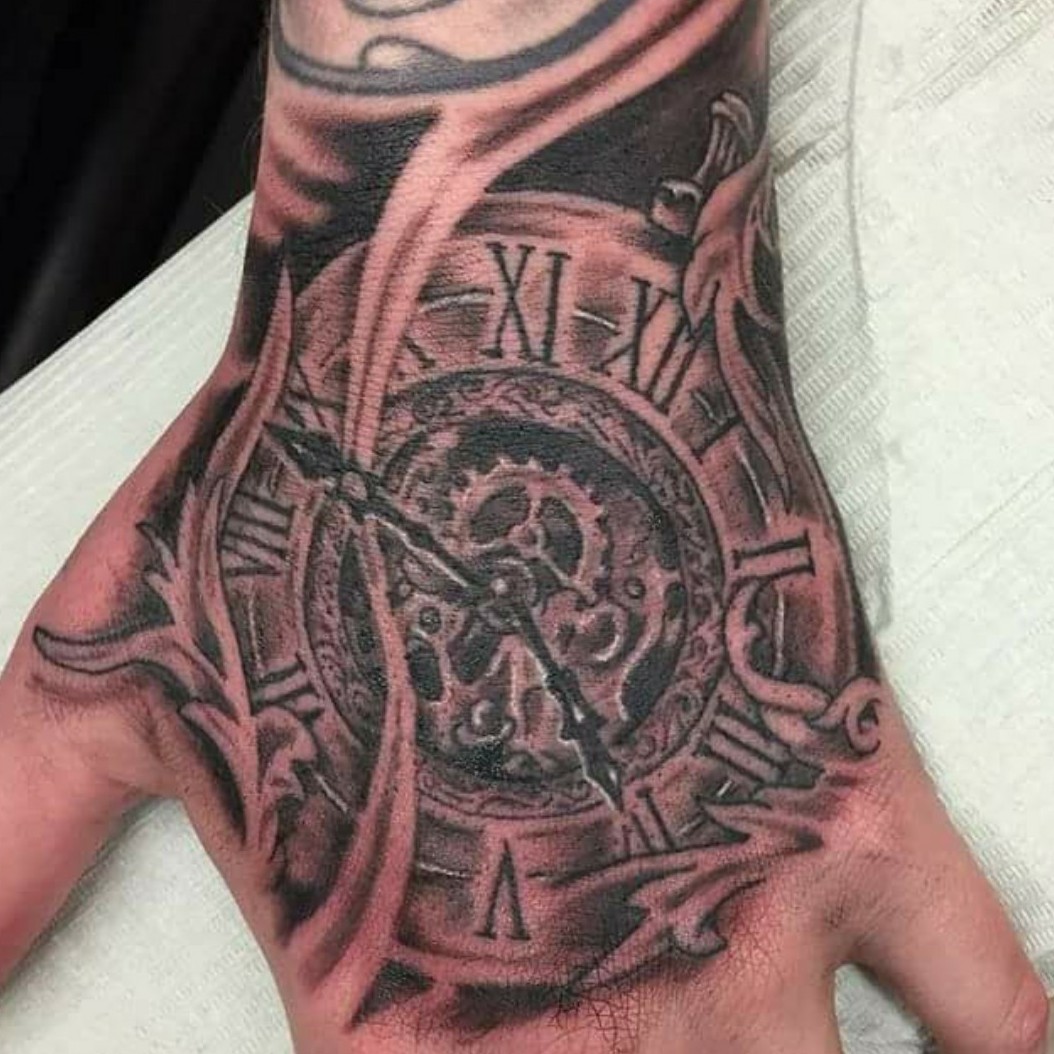 eye-catching clock tattoos for men on hand themes.