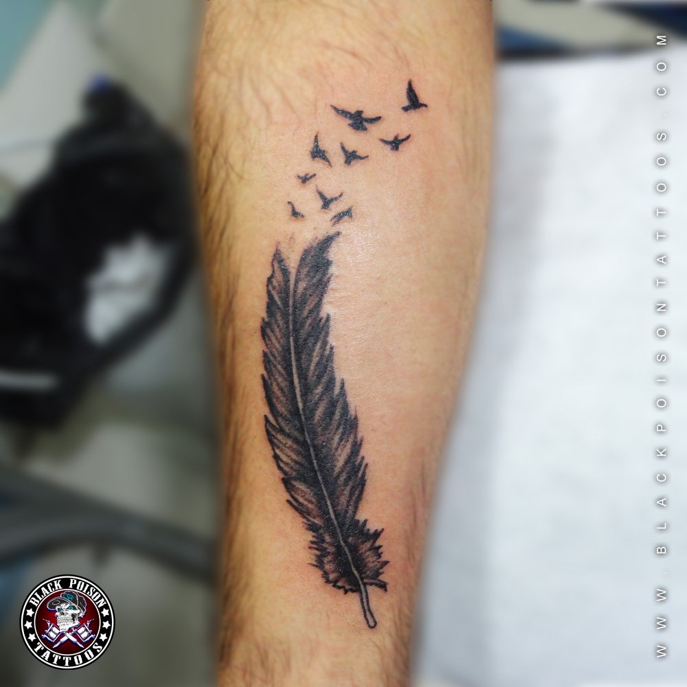 feather tattoo symbolism for men