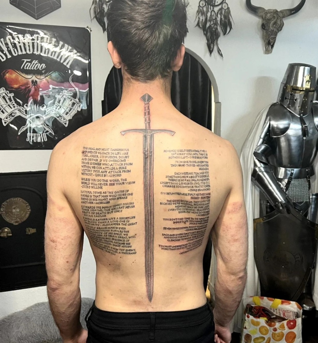 fierce back tattoos for men showcasing swords.