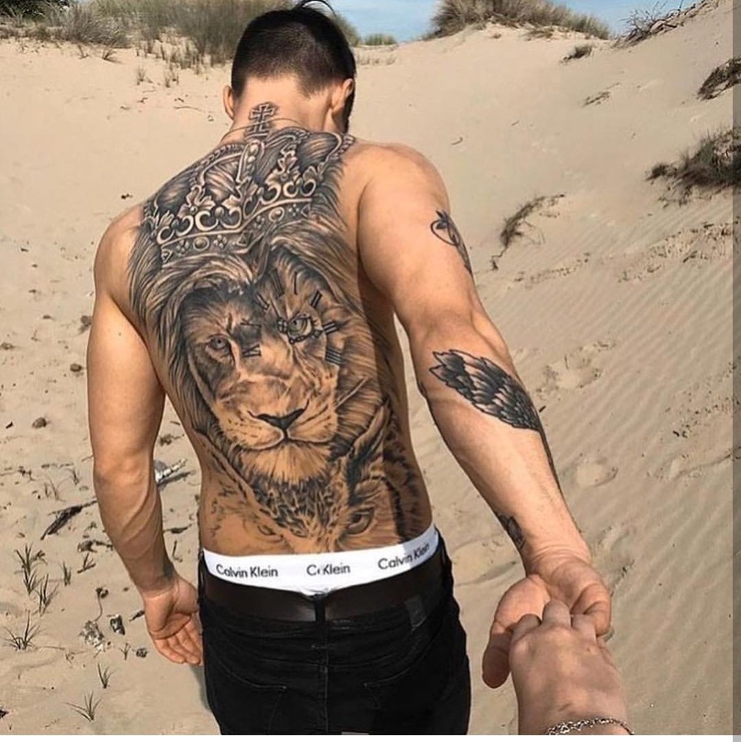 fierce lion back tattoos for men