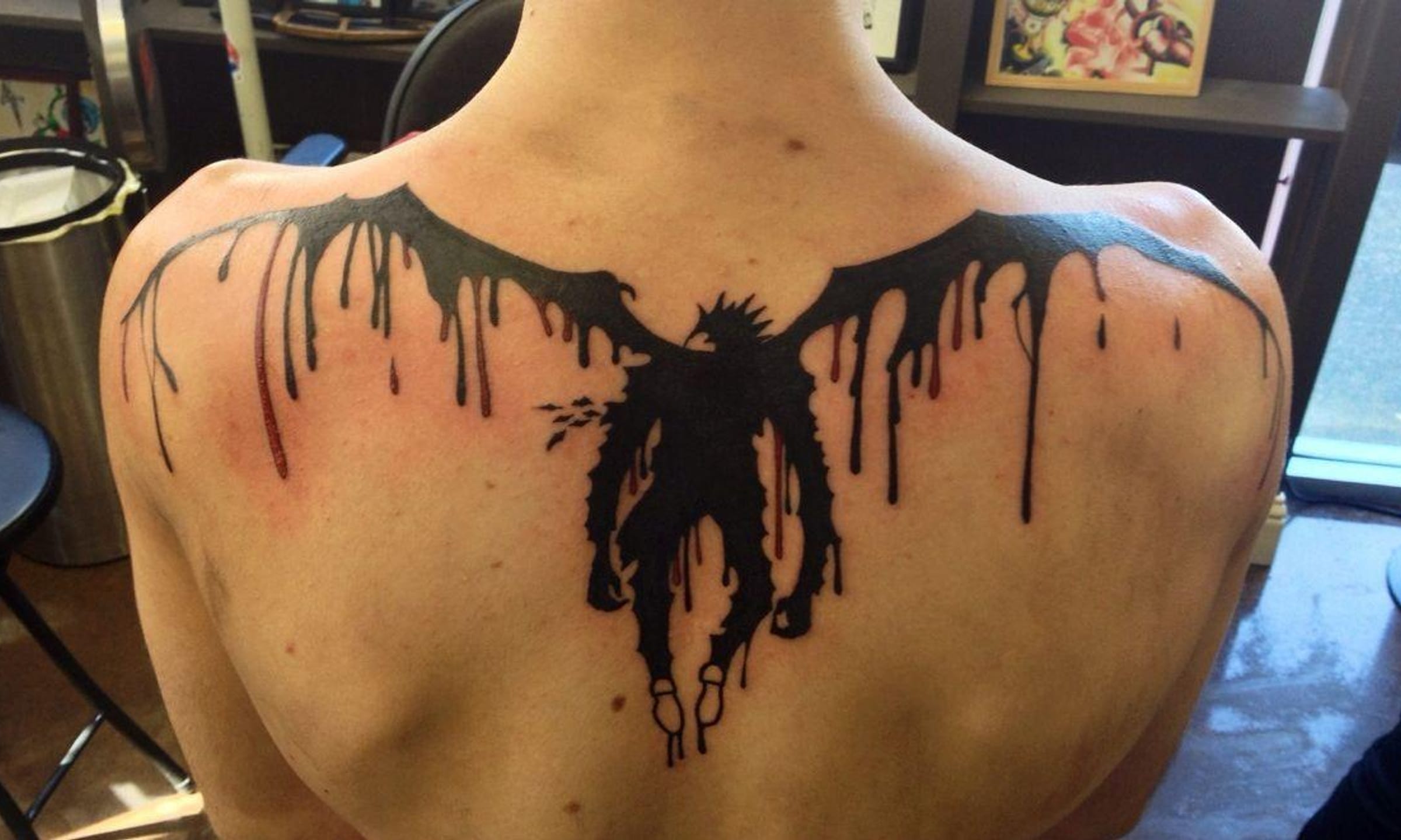 intricate back tattoos for men featuring anime art