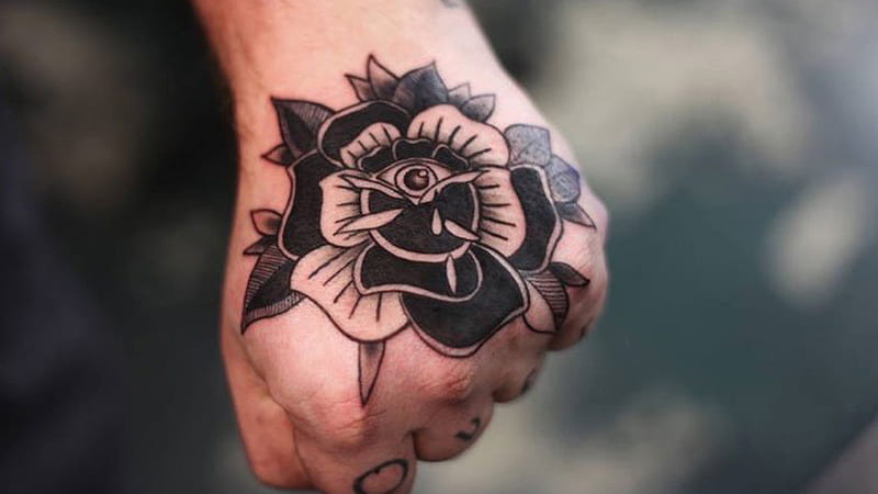 intricate flower tattoos for men on hand inspiration.