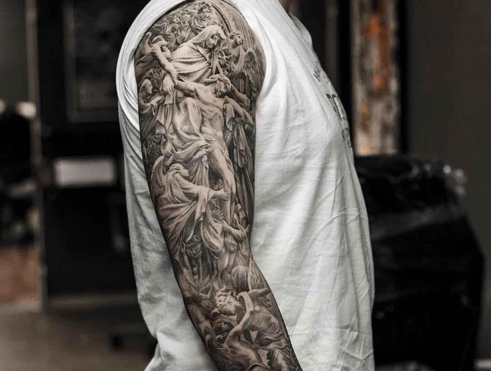 meaningful religious sleeve tattoos for men