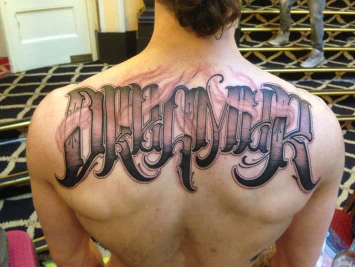 minimalist back tattoos for men featuring letters