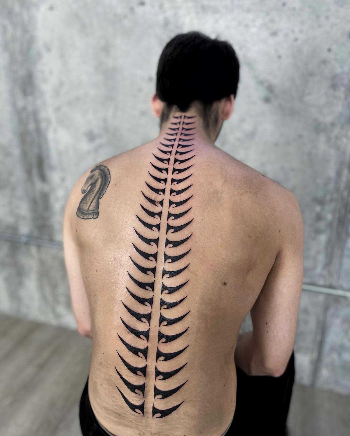 spine tattoos for men meaning