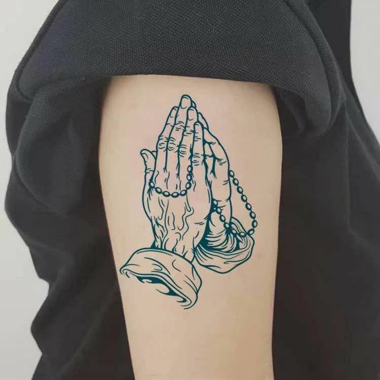 tattoos for men with praying hands symbolism