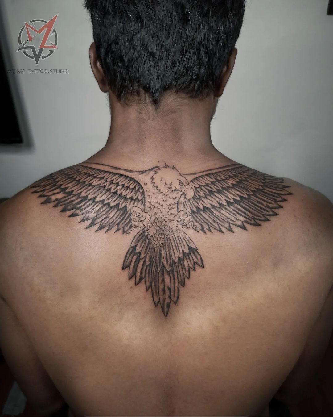 Back eagle tattoos for men effortlessly symbolize strength and freedom