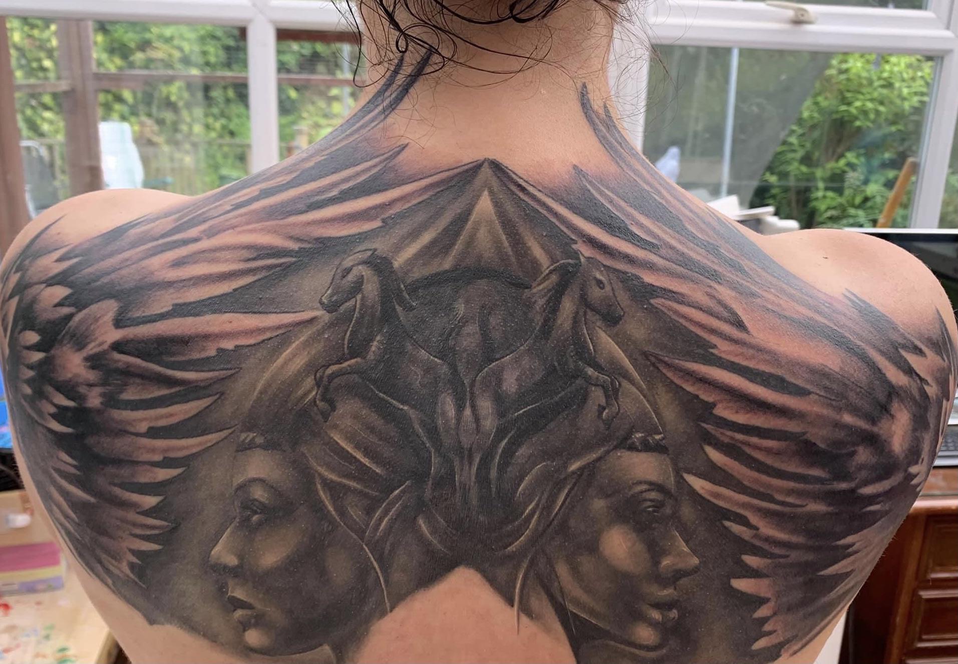 Upper back tattoo cover up ideas for men that blend style and meaning