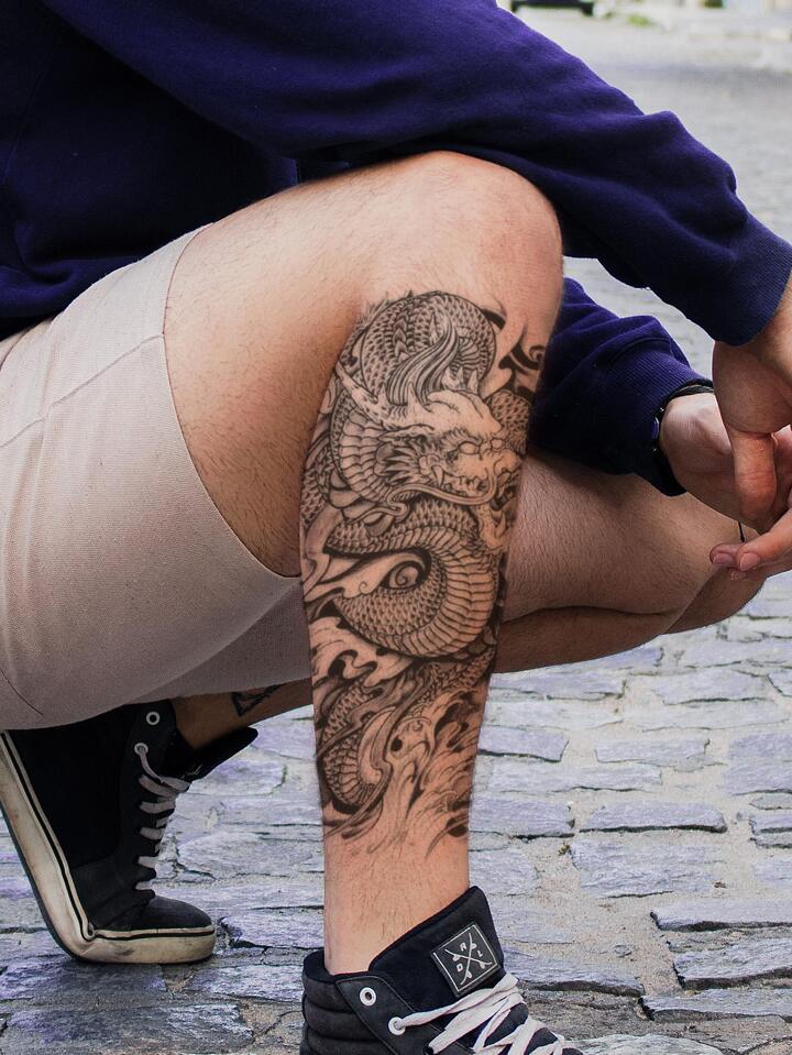 Dragon leg tattoos for men symbolize strength and resilience through artistry and design