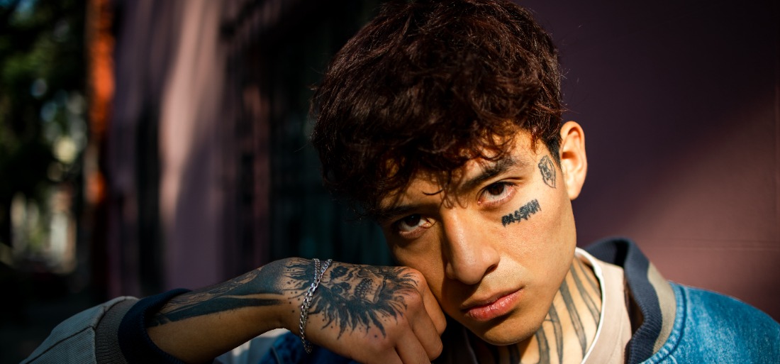 Fresh face tattoos for men Cross designs that showcase bold expressions and style